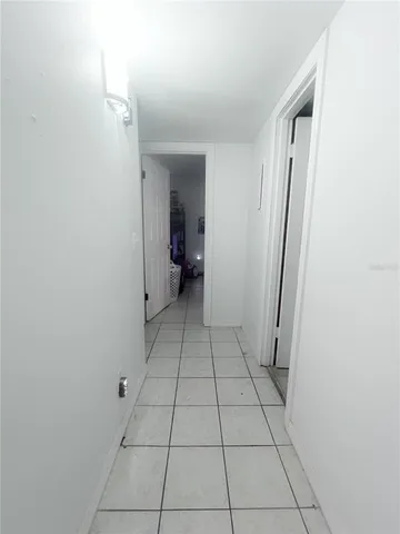 a view of an empty room and a bathroom