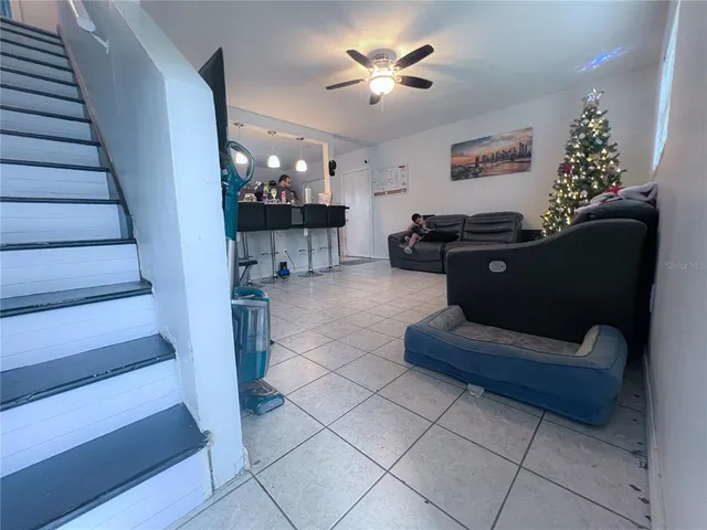 a living room with furniture and a chandelier