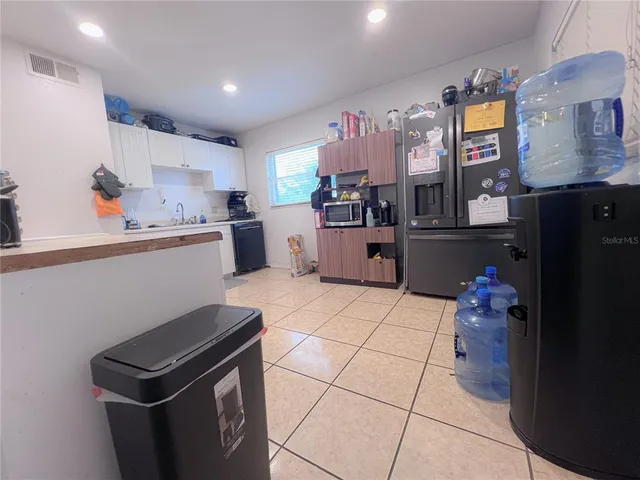 a kitchen with stainless steel appliances kitchen island granite countertop a refrigerator and a stove