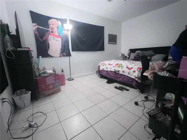 a bedroom with furniture and a flat screen tv