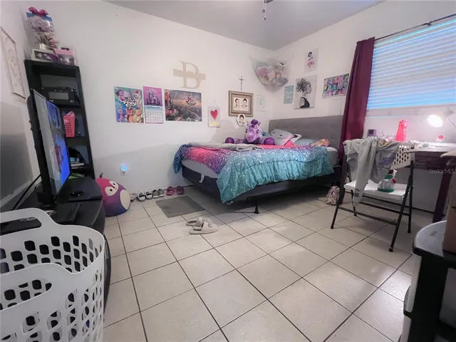 a bedroom with furniture and a chair