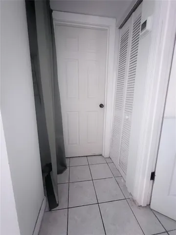 a view of a closet area with hardwood floor