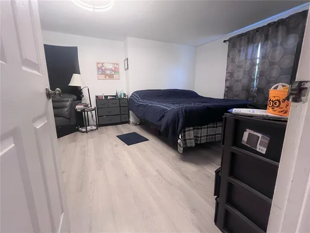 a bedroom with a bed and a television