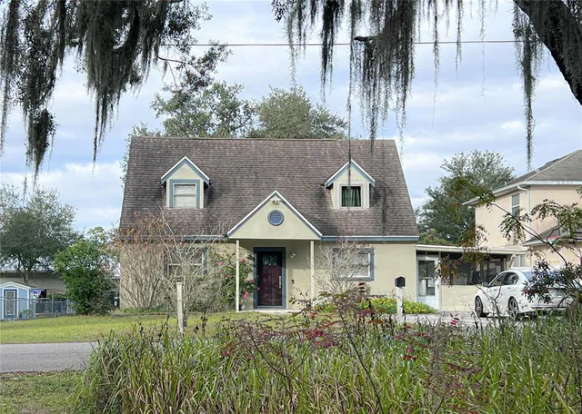 a aerial view of a house with a yard and potted plants
