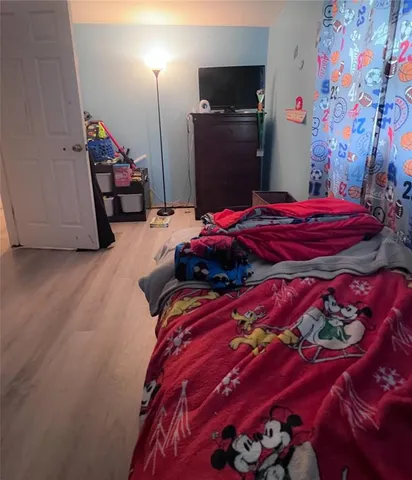 a bedroom with a bed and a lamp