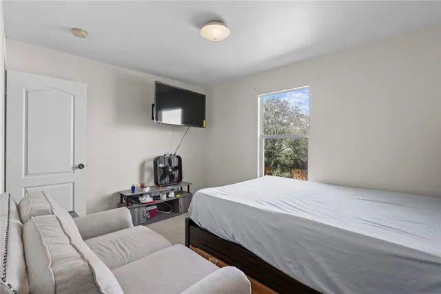 a bedroom with a bed and window