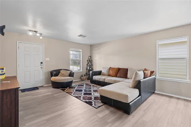 a living room with furniture and wooden floor