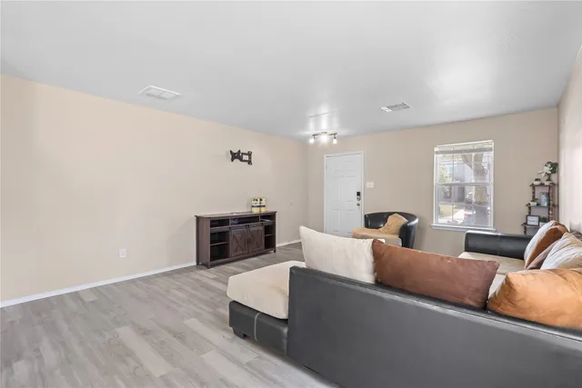 a living room with furniture wooden floor and window