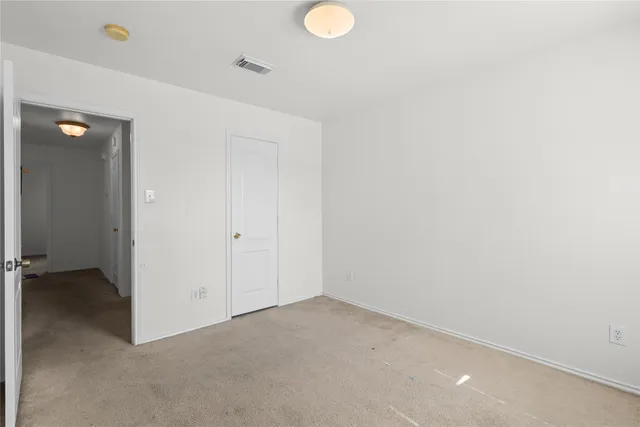 a bedroom with a bed and a television