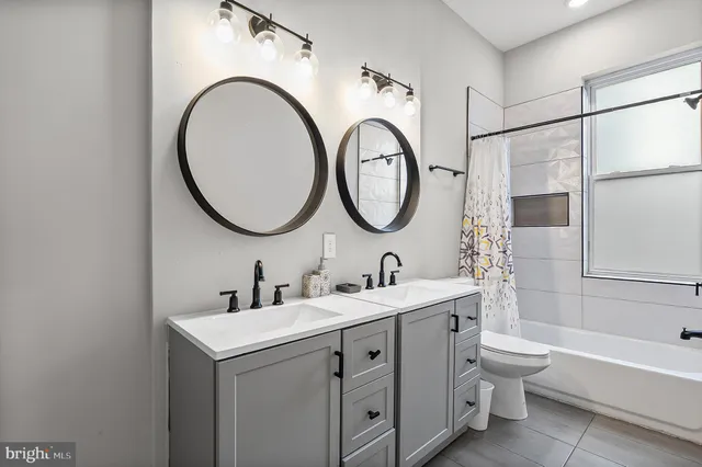 a bathroom with a toilet a sink and a mirror