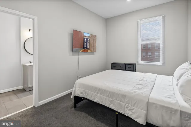 a bedroom with a bed and a window