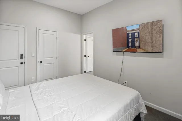 a bedroom with a bed and a wall painting