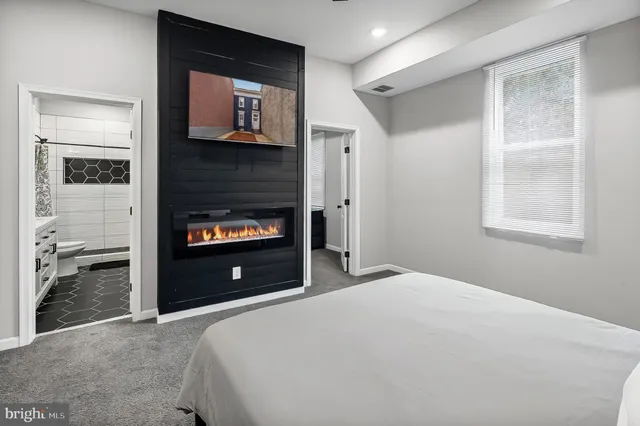 a bedroom with a bed and a fireplace