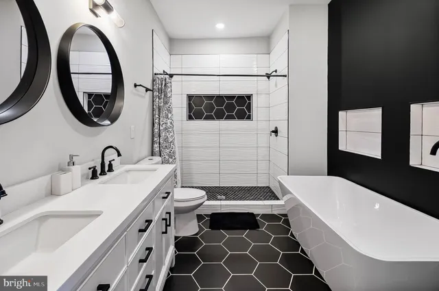 a bathroom with a sink a toilet and a mirror