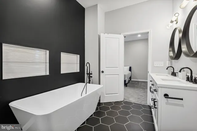 a bathroom with a bathtub sink and mirror