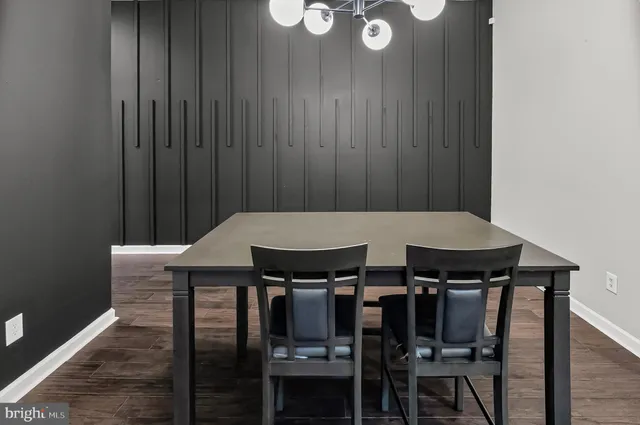 a view of a dinning table and chairs in wooden floor