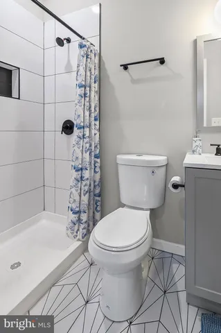 a bathroom with a toilet and shower