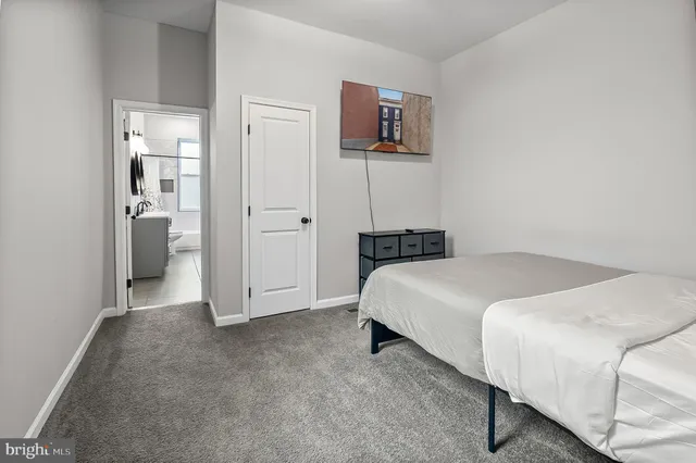 a bedroom with a bed and a tv