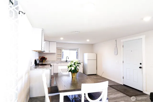 a kitchen with stainless steel appliances granite countertop a refrigerator and a sink