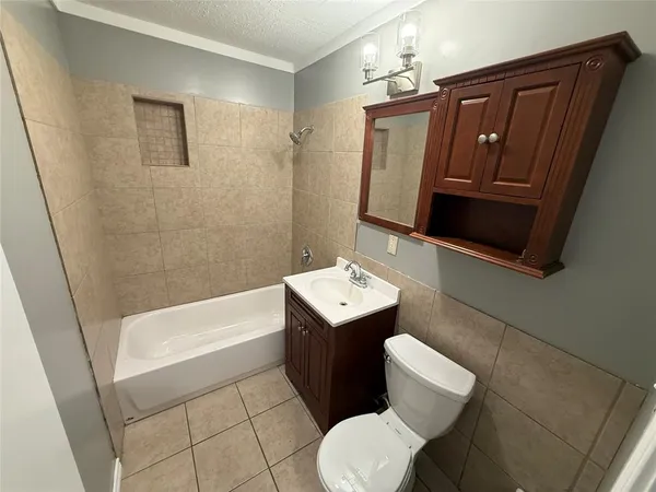 a bathroom with a sink a toilet and bathtub