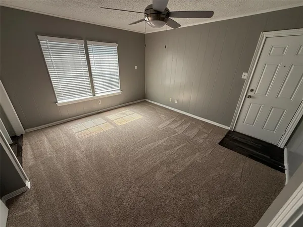 an empty room with windows and entrance