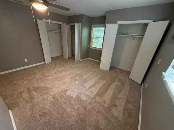 a view of an empty room with a fireplace