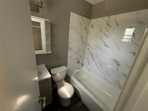 a white toilet sitting next to a shower curtain