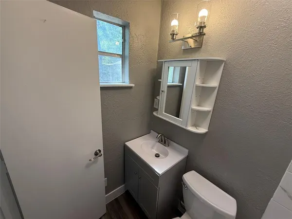 a bathroom with a toilet sink and mirror