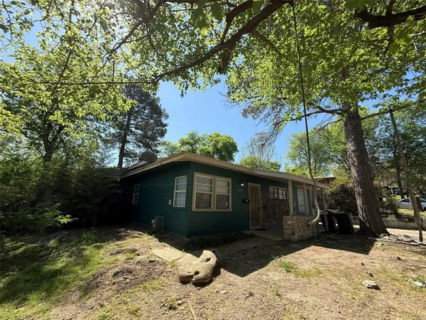 a front view of a house with a yard covered in snow