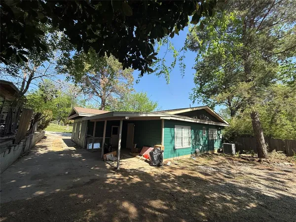 a view of a house with a yard and tree s