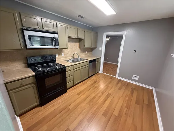 a kitchen with granite countertop a stove and a sink