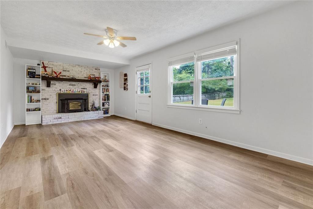 5800 Cedar Lane Southwest Mableton, GA 30126 - Photo 15 of 41 wooden floor fireplace and windows in an empty room