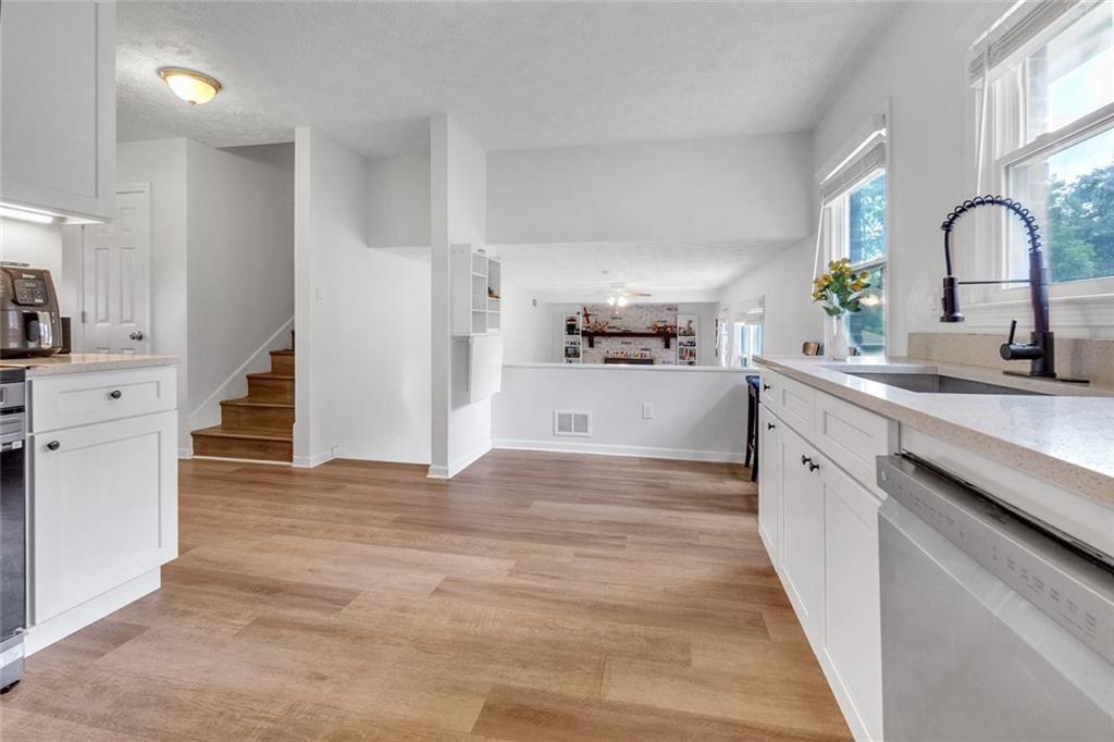 5800 Cedar Lane Southwest Mableton, GA 30126 - Photo 21 of 41 a kitchen with a refrigerator sink and white cabinets