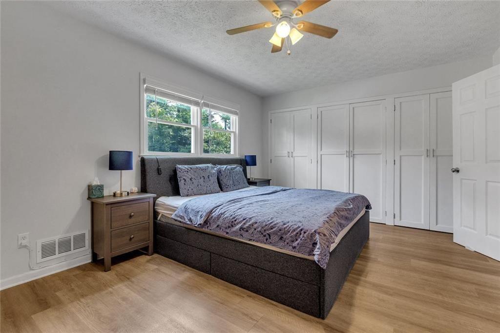 5800 Cedar Lane Southwest Mableton, GA 30126 - Photo 27 of 41 a spacious bedroom with a bed and a chandelier