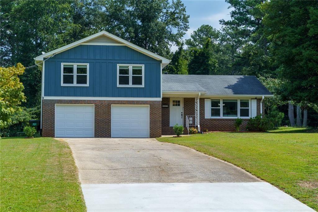 5800 Cedar Lane Southwest Mableton, GA 30126 - Photo 38 of 41 a front view of a house with a yard and garage