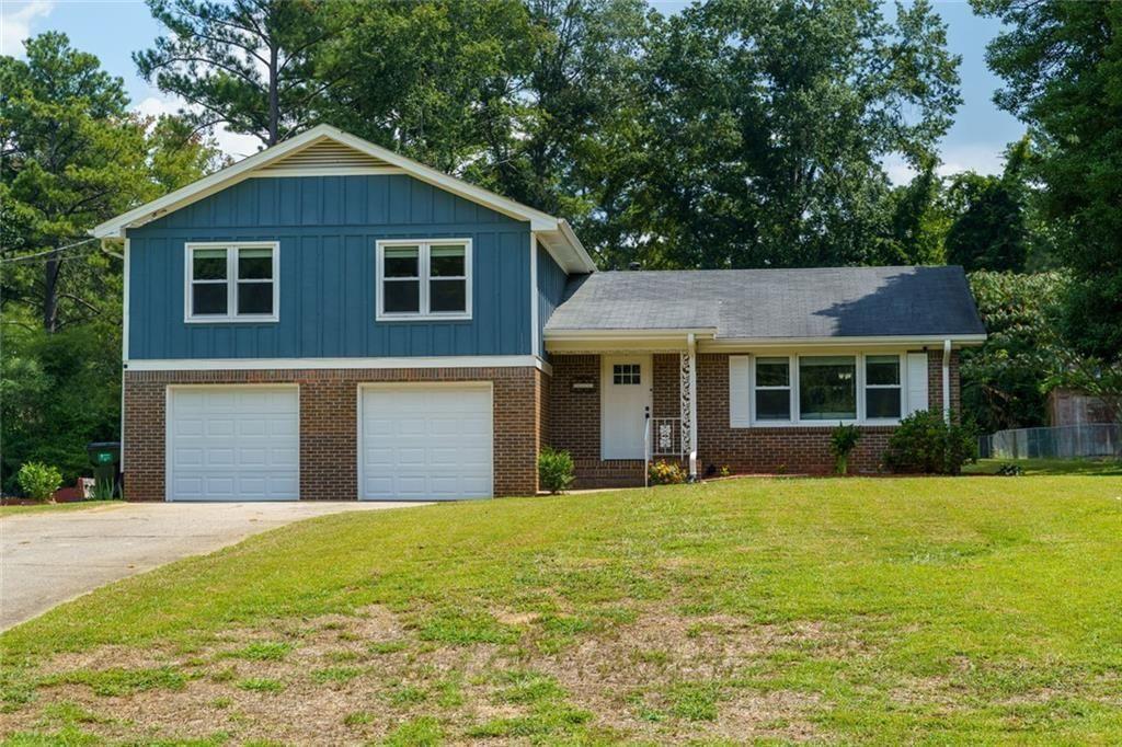 5800 Cedar Lane Southwest Mableton, GA 30126 - Photo 39 of 41 a front view of a house with a yard and garage