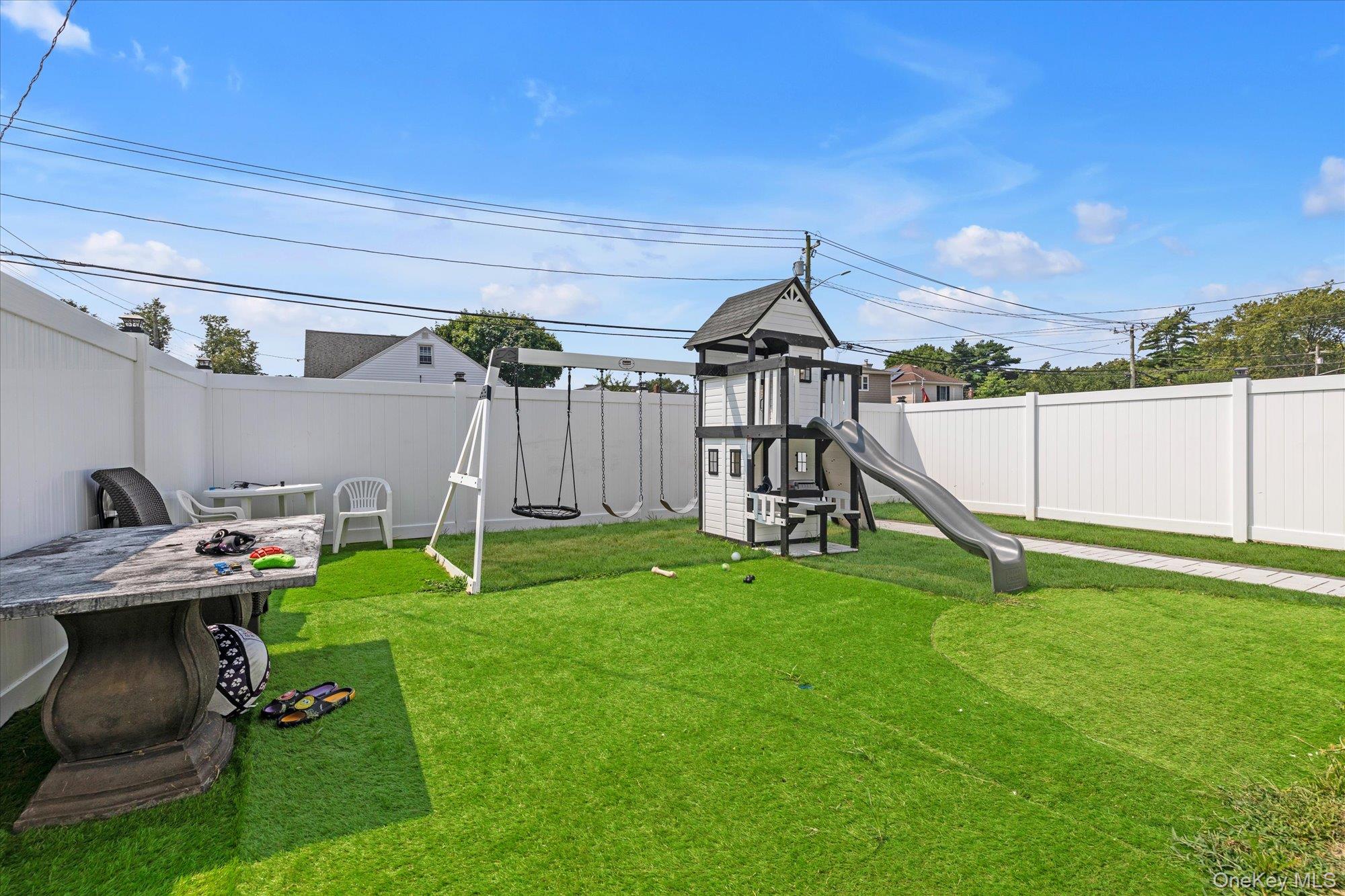 190 Commonwealth Street Franklin Square, NY 11010 - Photo 13 of 16 a view of a house with a porch and a bench