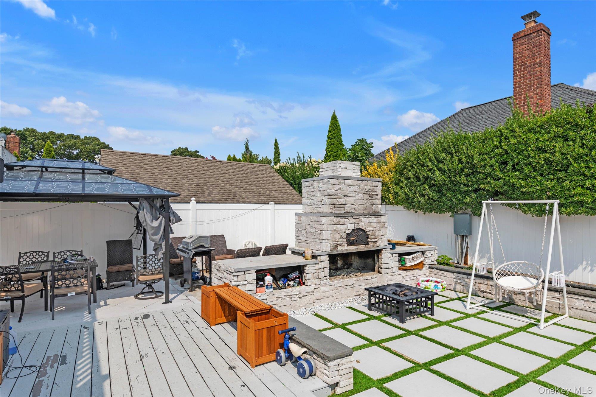 190 Commonwealth Street Franklin Square, NY 11010 - Photo 14 of 16 a view of a patio with table and chairs with wooden floor and fence