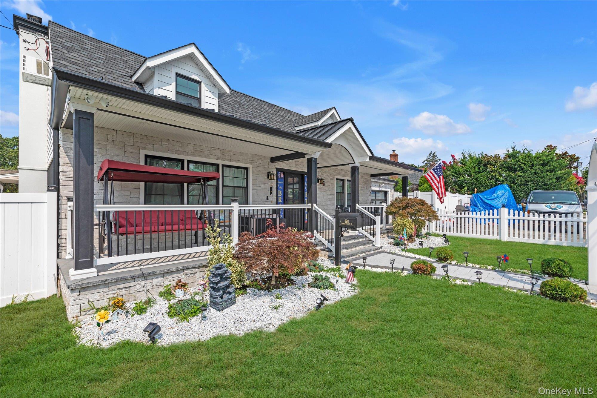 190 Commonwealth Street Franklin Square, NY 11010 - Photo 16 of 16 a front view of a house with a garden and yard