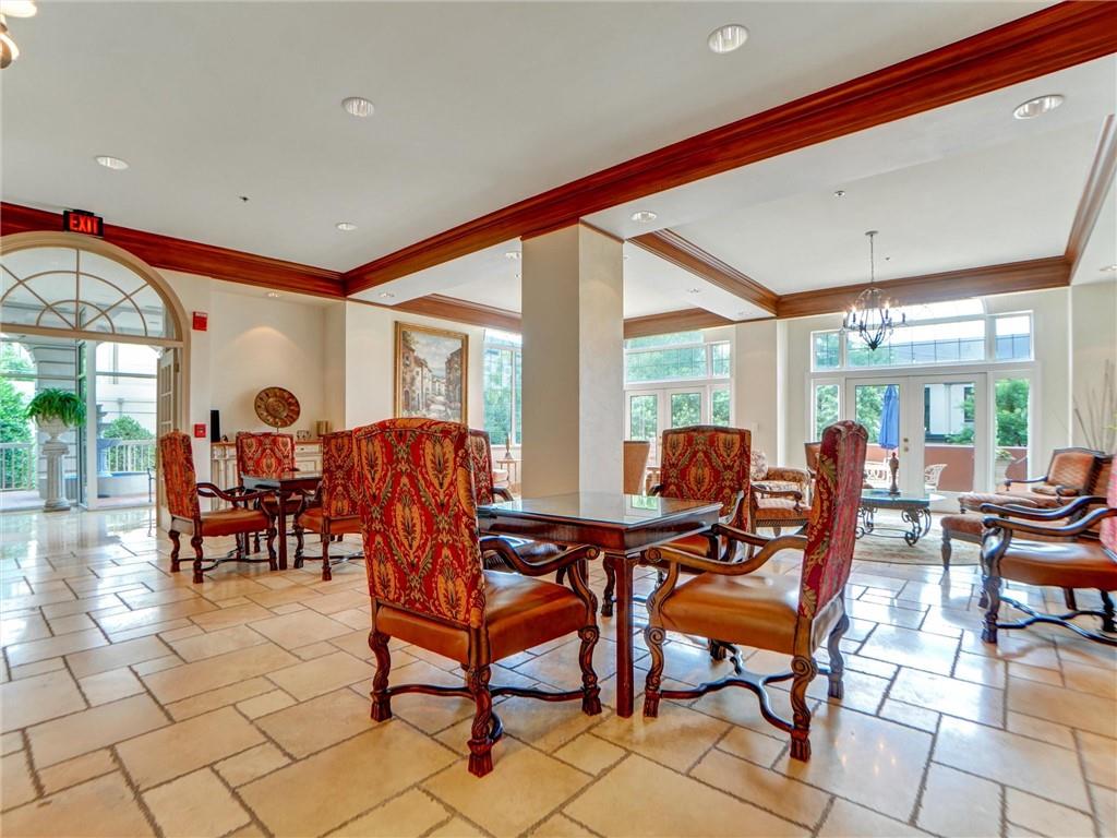 3435 Kingsboro Road Northeast, Unit 1601 Atlanta, GA 30326 - Photo 52 of 54 a dining room with furniture and a large window
