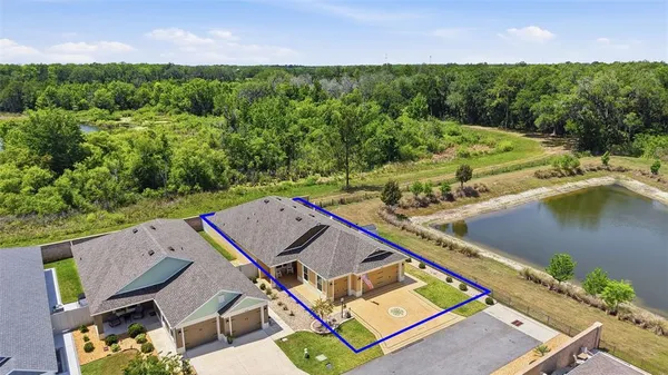 an aerial view of a house with a yard and lake view