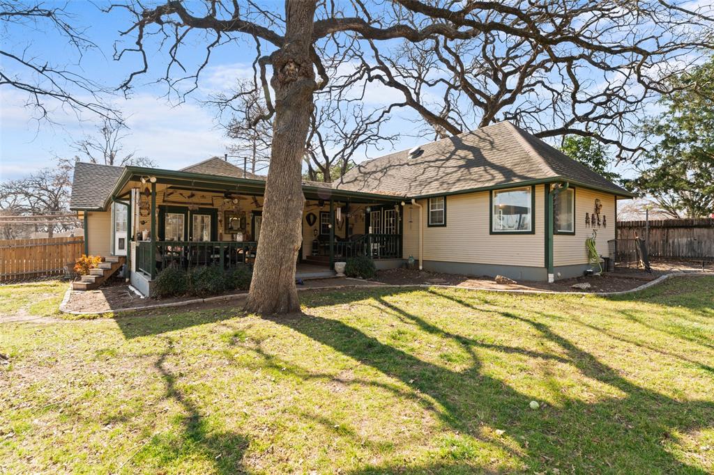 Back of property featuring a shingled roof and a patio area