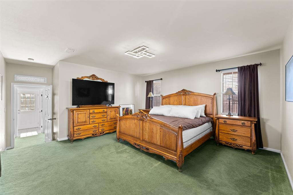805 East Shady Grove Road Irving, TX 75060 - Photo 13 of 36 Bedroom with carpet flooring and baseboards
