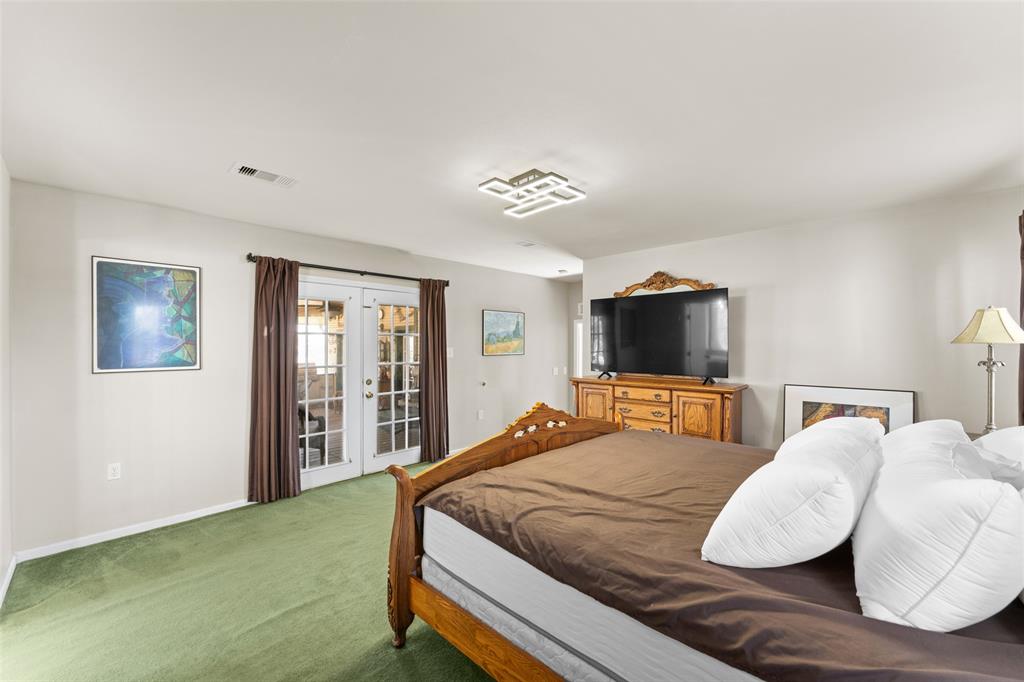 805 East Shady Grove Road Irving, TX 75060 - Photo 14 of 36 Carpeted bedroom with french doors and access to outside