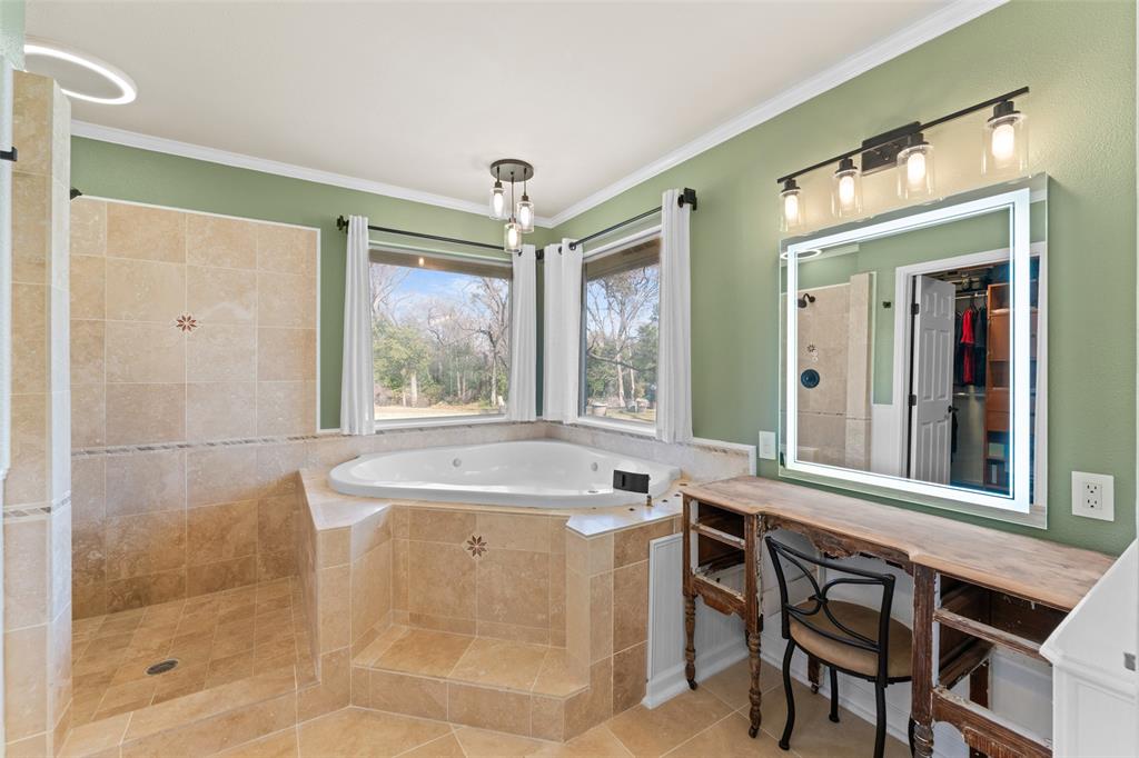 805 East Shady Grove Road Irving, TX 75060 - Photo 15 of 36 Full bath with a bath, a tile shower, tile patterned floors, ornamental molding, and vanity