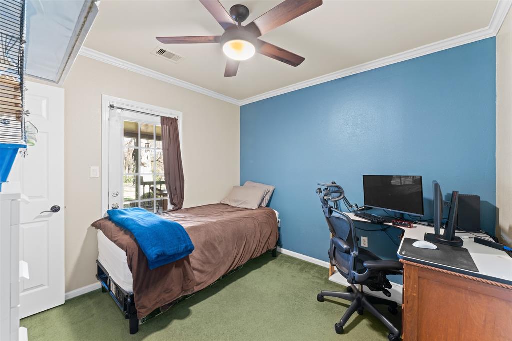 805 East Shady Grove Road Irving, TX 75060 - Photo 18 of 36 Bedroom with a desk, crown molding, access to exterior, carpet flooring, and ceiling fan