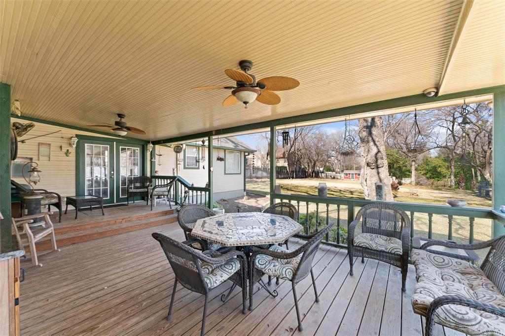805 East Shady Grove Road Irving, TX 75060 - Photo 2 of 36 Wooden terrace featuring a ceiling fan, outdoor dining area, and french doors