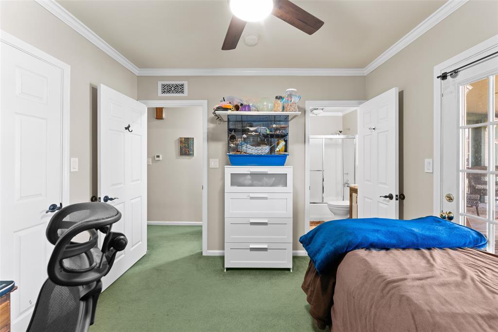 805 East Shady Grove Road Irving, TX 75060 - Photo 19 of 36 Carpeted bedroom with crown molding, ceiling fan, and ensuite bathroom