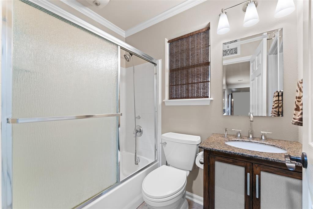 805 East Shady Grove Road Irving, TX 75060 - Photo 21 of 36 Bathroom with vanity, enclosed tub / shower combo, and ornamental molding
