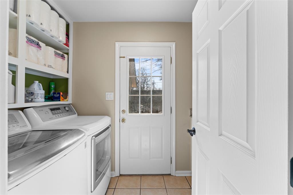 805 East Shady Grove Road Irving, TX 75060 - Photo 22 of 36 Laundry room featuring separate washer and dryer and light tile patterned floors